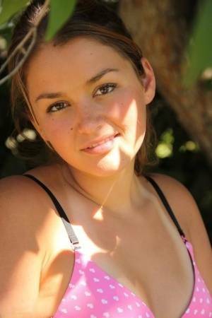 Petite amateur Allie Haze shows her tan lined body in the shade of a tree on girlsfollowers.com