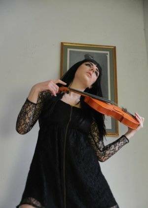 Dark haired violin player Sam Bentley strikes great poses while getting naked on girlsfollowers.com