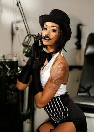 Ebony pornstar Skin Diamond strutting in vintage hat and long gloves on girlsfollowers.com