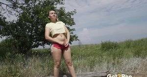 Gorgeous European sits on a log to piss outside on girlsfollowers.com